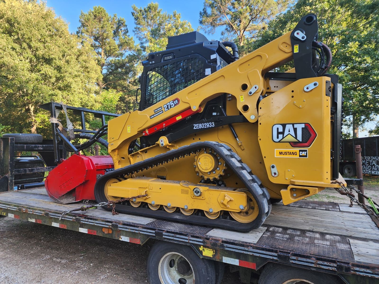 CAT track loader with forestry mulcher head on trailer Texas